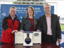 Iain Weir, Marketing Director, Ian Macleod Distillers Ltd. presents a rare bottle of Isle of Skye 21 Year Old to competition winner, Nigel Young and his partner.
